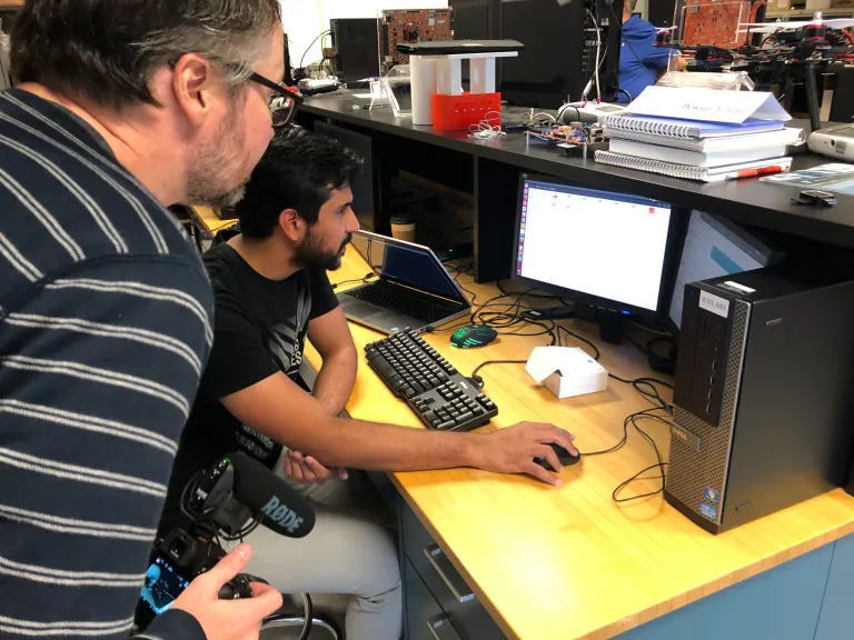 two men looking at a computer screen